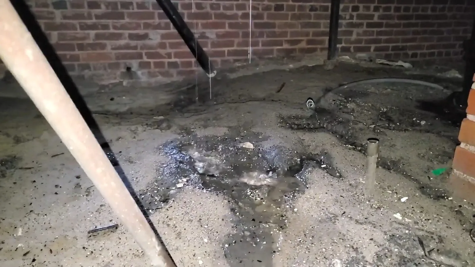 A drain line re-sloped and supported inside a crawl space during a service visit in Downtown Alpharetta