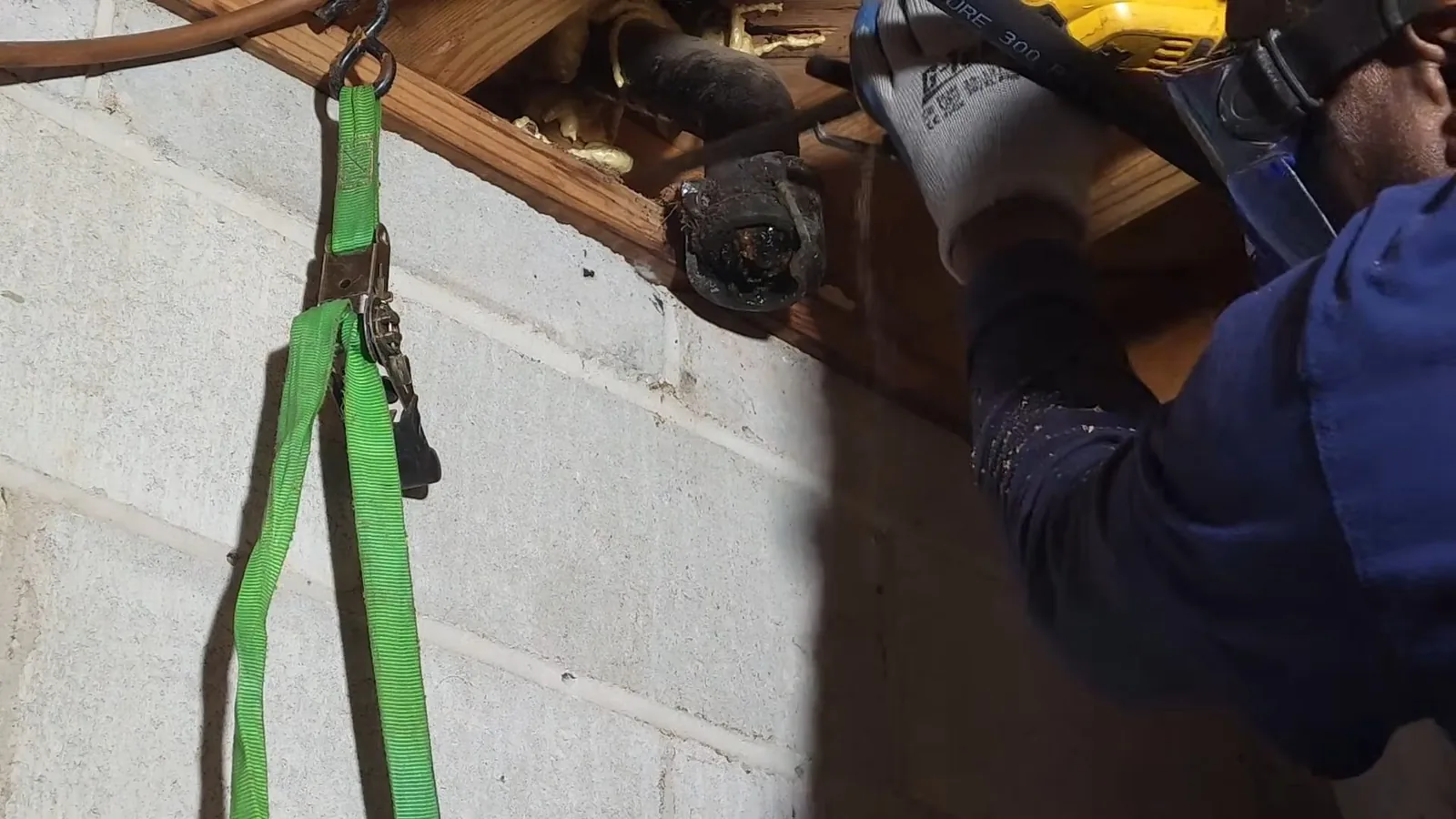 Cast iron pipe compared side by side with its PVC replacement during a service visit in Norcross, GA