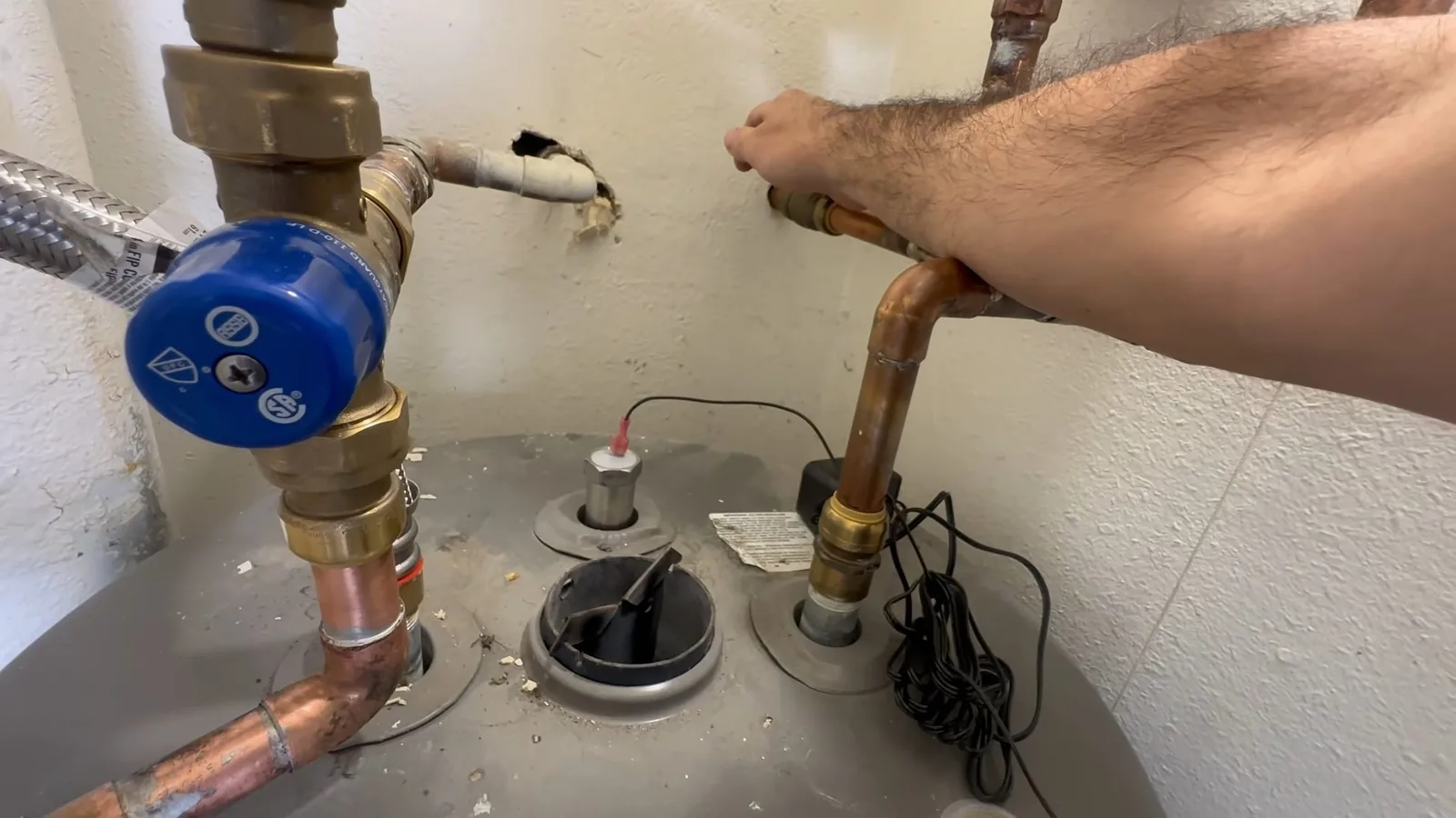 Corrosion visible on a water heater's inlet fitting during a service visit in Webb Bridge