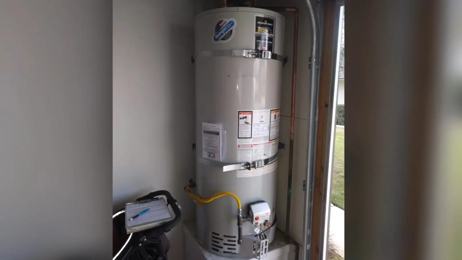 A leaking water heater inlet hose being replaced, representing Water Heater Repair service