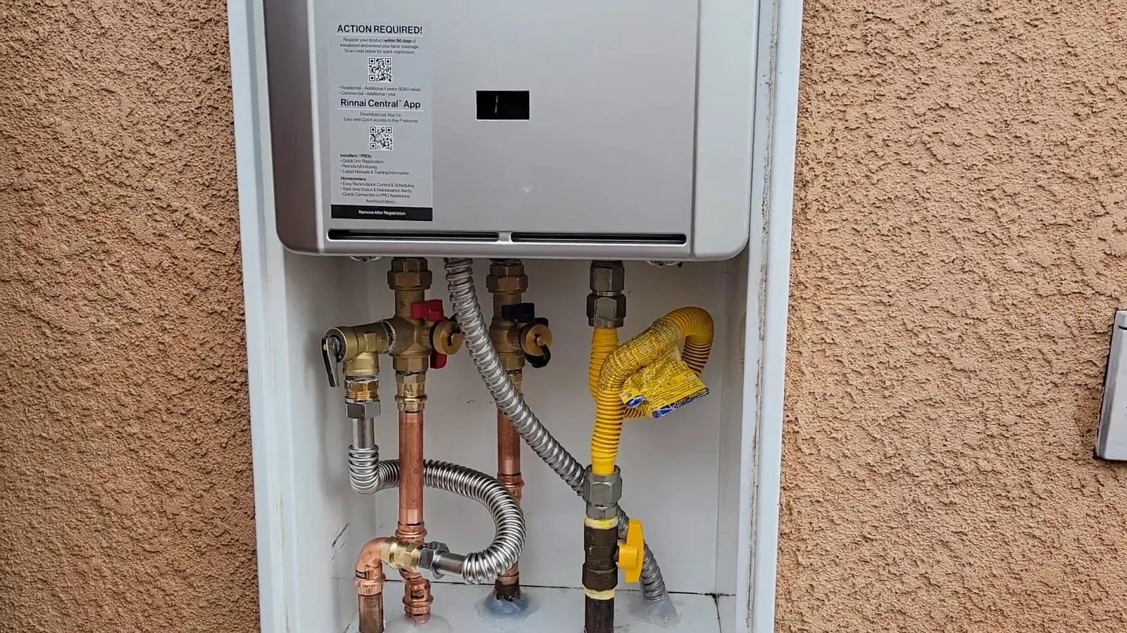 A tankless water heater mounted on an interior wall, representing Tankless Water Heater Services service