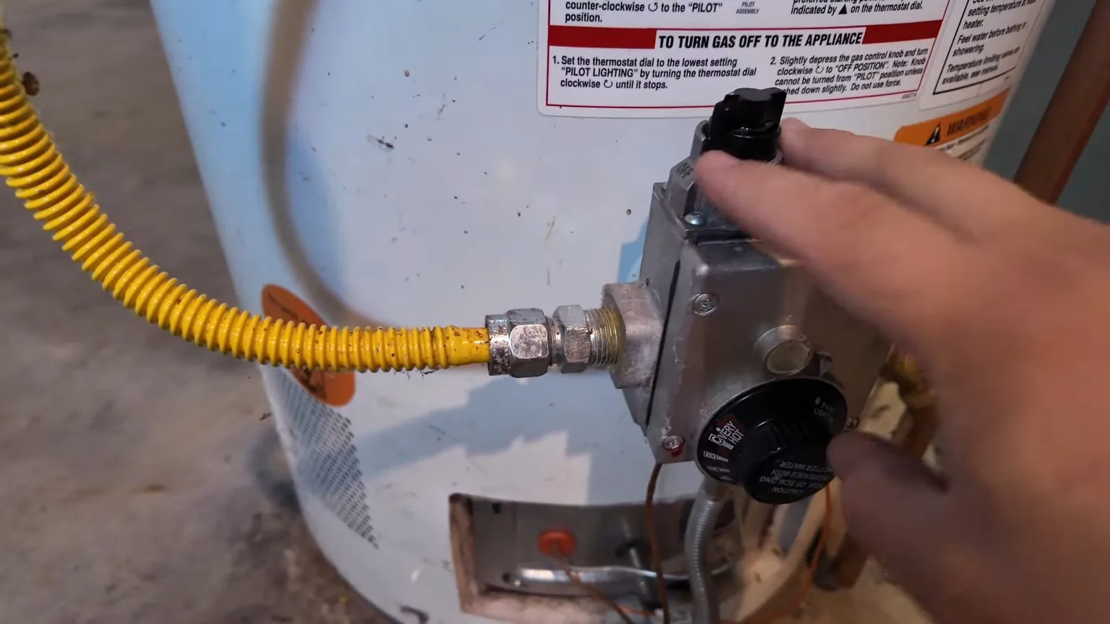 A water heater's cold and hot supply lines being connected, representing plumbing service in Sandy Springs, GA